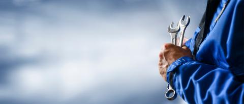 Wrench in a maintenance workers hand.